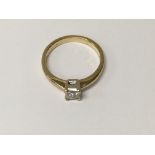 A 18 ct gold ring inset with a singe diamond size j