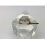 A pave set heart gold ring with stone set shoulder