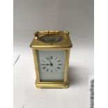 A brass gilt case carriage clock with repeat butto