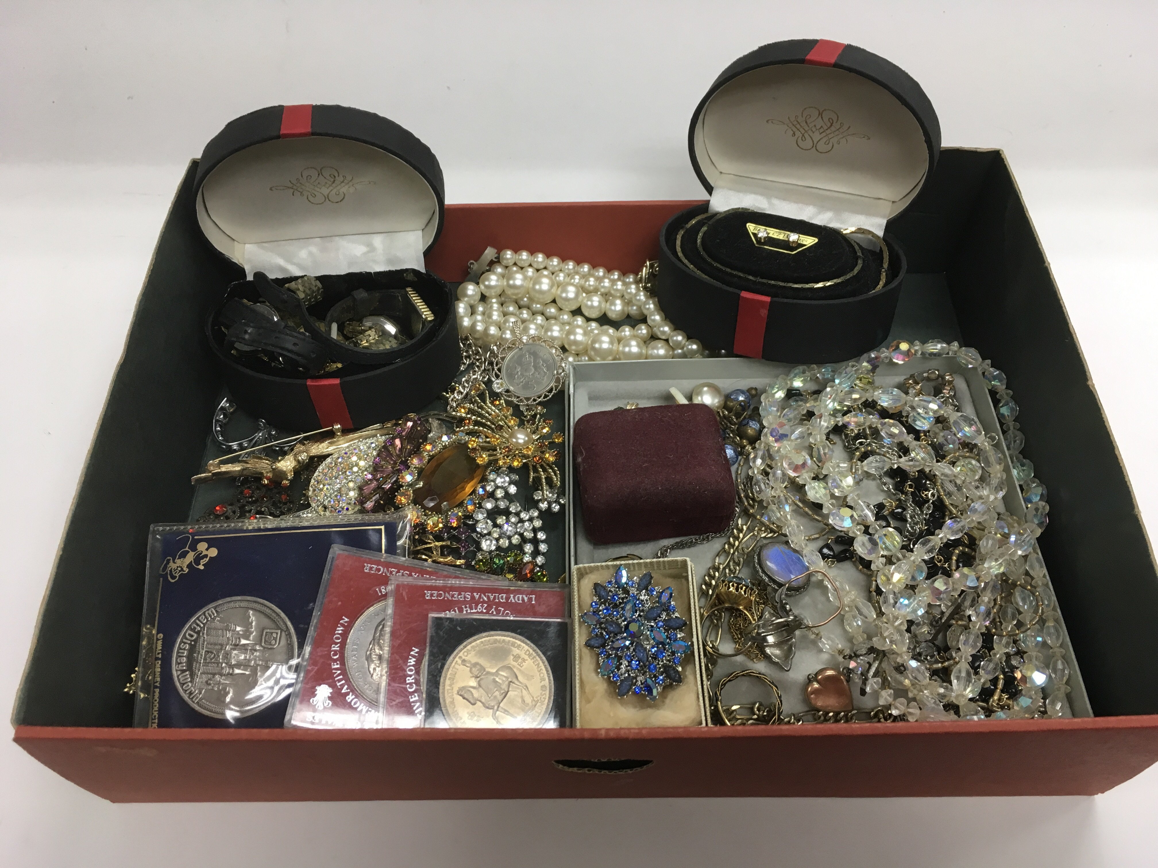 A box of costume jewellery including a gold locket