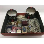 A box of costume jewellery including a gold locket