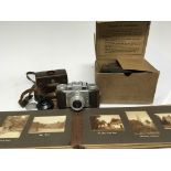 A vintage Baraun Paxette Camera a World War II gas mask and a well present photo album of British