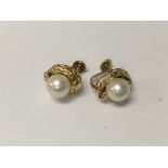 A pair of gold back earrings inset with pearls