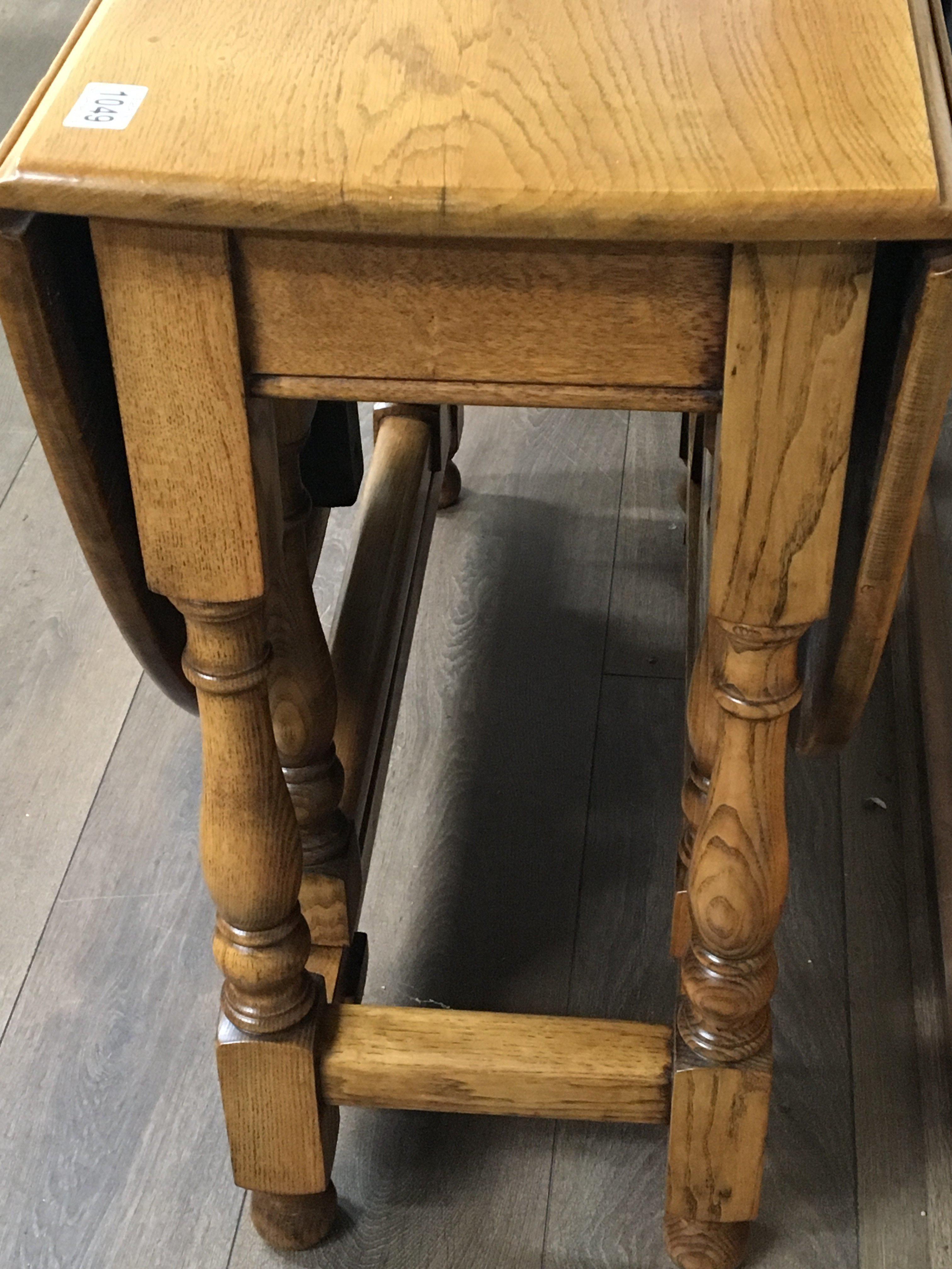 A solid light oak drop leaf table the twin flap top on turned legs. - Image 2 of 3