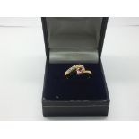 A 9ct gold ring set with white and pink (padparads