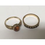 Two 9carat gold rings one set with amber and the o