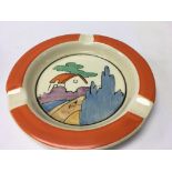 A Clarice Cliff ash tray decorated with house and