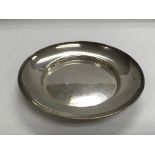 A circular silver dish, London hallmarks, approx d