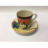 A Clarice Cliff coffee can and saucer decorated wi