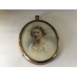 A 19th Century portrait watercolour miniature depicting a young girl in a floral pattern embroidered