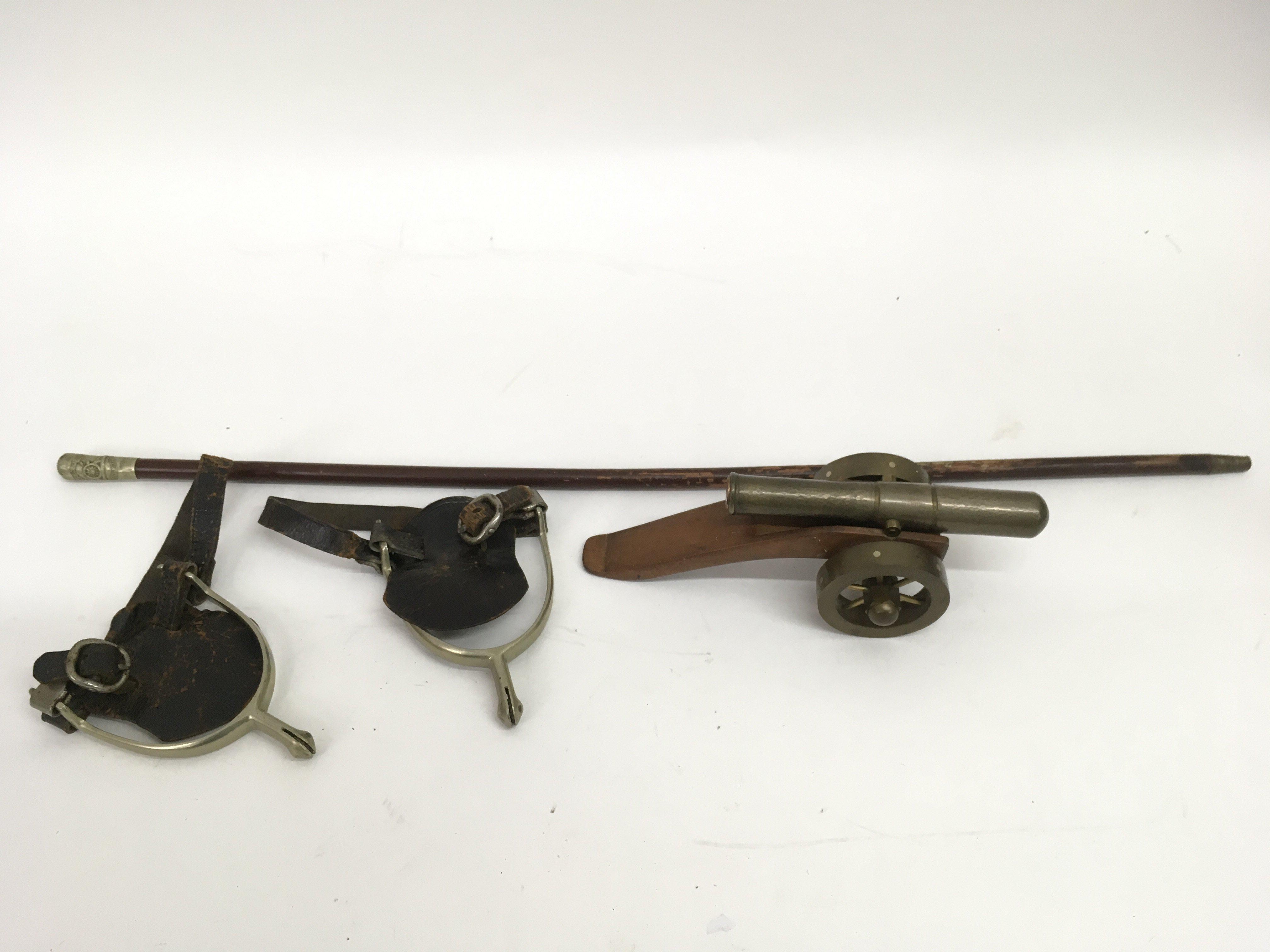 A swagger stick, pair of spurs and model canon - N