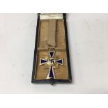 A German WW2 gold mothers cross medal. In copy box
