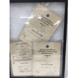 A frame containing three German WW2 certificates f