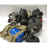 A collection of mixed gas masks including French a