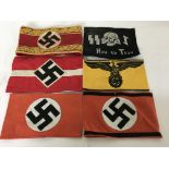 A group of armbands to include 5 German style WW2