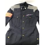 A military dress uniform, with patches and badges.