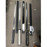 A group of three Japanese style replica swords, in