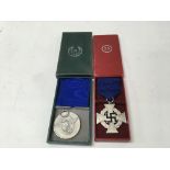 A pair of German WW2 service medals, including an