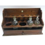 A 19th Century apothecary chemist stand and three bottles.