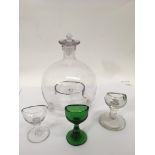 An antique glass fly trap and four eye glasses