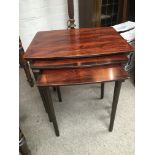 A nest of three modern rosewood tables.