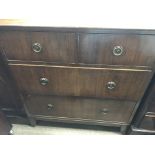 A small mahogany chest of drawers fitted with two short and three long drawers on bracket feet