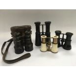 Four pairs of binoculars including a pair with bone casing.