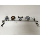 An old car badge bar with five badges
