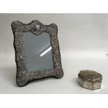 A silver trinket box and silver frame.