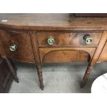 A Georgian mahogany chest of drawers fitted with two drawers flanked by cupboards