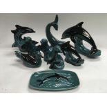 A collection of Poole animal figures comprising mainly dolphins.