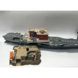 A box containing a collection of LGTI micro toys, including an aircraft carrier and various
