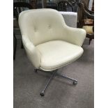 A vintage cream leather swivel chair.