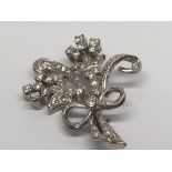 A Quality white gold brooch set with a pattern of diamonds with simulated ribbon tie and small