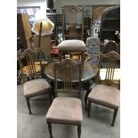 A circular dining table and four chairs, table approx diameter 100cm.