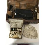 A leather vanity case , a baby's bonnet, a vintage leather handbag and a case of threads and beads