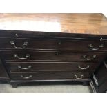 A Georgian mahogany chest of drawers with brushing slide fitted with four drawers on bracket feet .