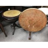 A mahogany drum table and a leather topped tilt top circular side table impressed with an elephant