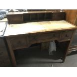 A walnut desk raised on tapering legs and terminating in spade feet, needs new leather top, approx