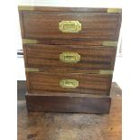 A small mahogany campaign style three drawer chest