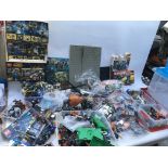 A large collection of Lego models , figures and loose bricks , including Star Wars, Ninjago, Batman,