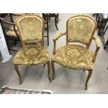 A set of six French Style beechwood chairs including two open armchairs with floral upholstery.