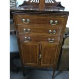 A Edwardian inlaid music cabinet fitted with three drawers and cupboards under