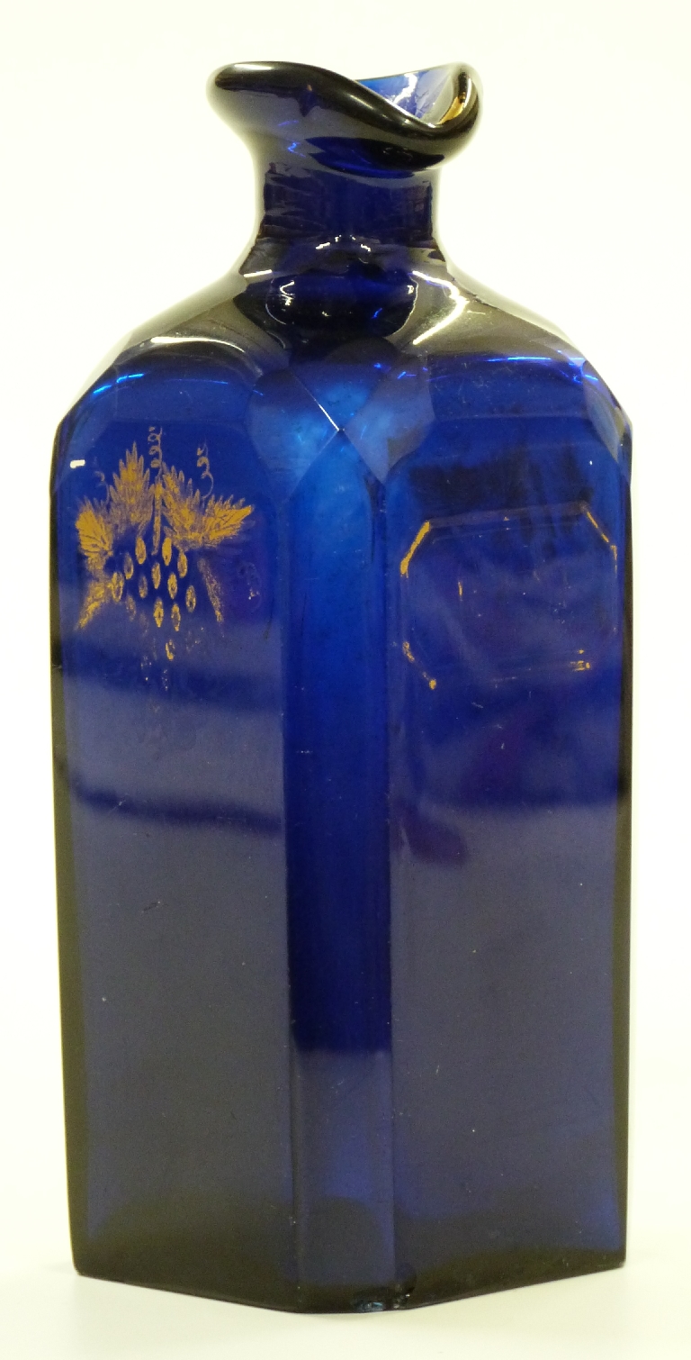 A 19th century Bristol blue glass 'Rum' decanter with faceted edges and gilt decoration, possible