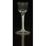 An 18thC clear drinking glass with opaque twist stem and ogee shaped bowl raised on conical foot,