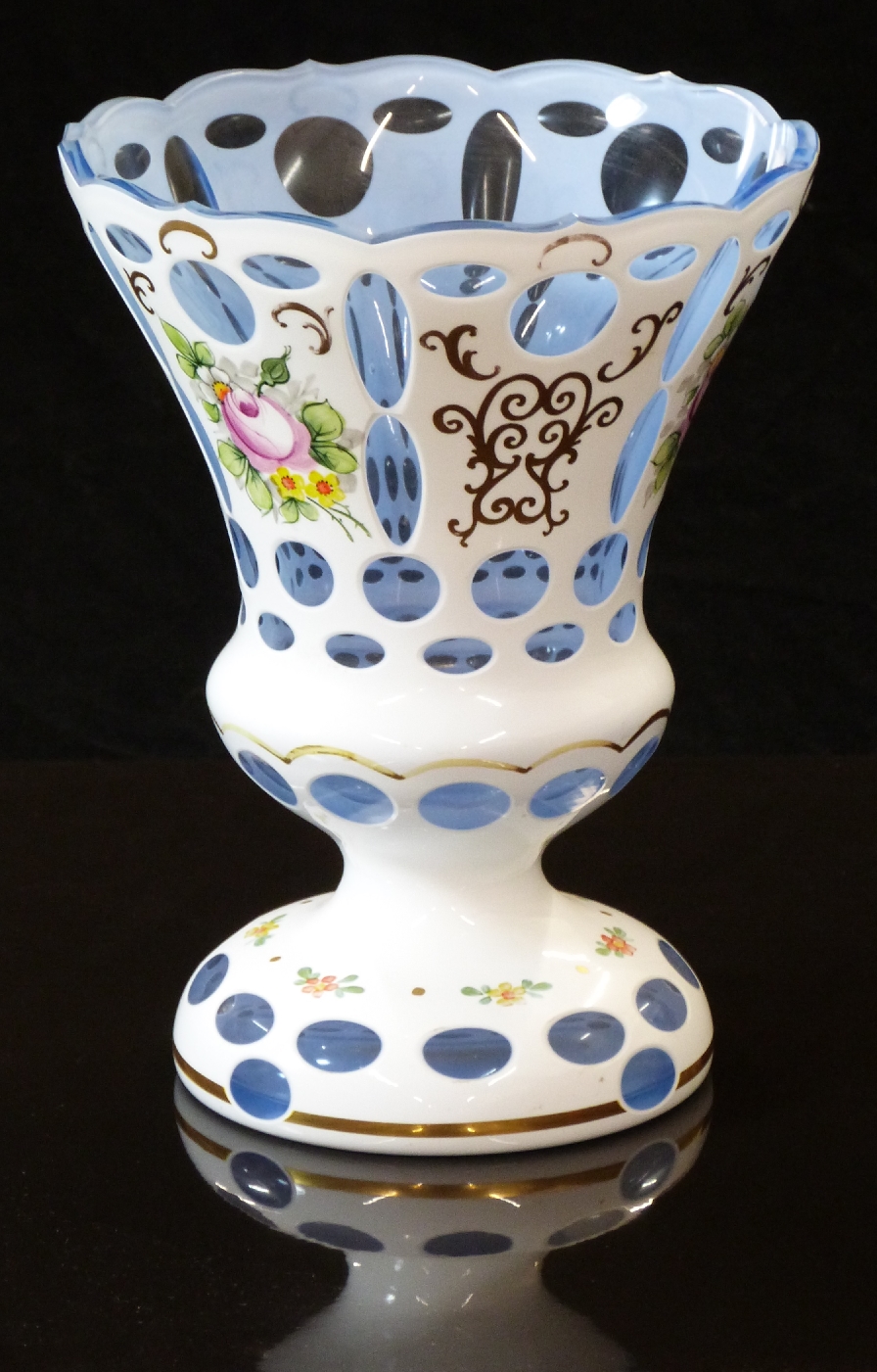 Overlaid cut glass vase with gilt and floral decroation on white over pale blue ground, 20cm tall.