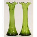 A pair of Art Nouveau green glass vases with frilled rims, 30cm tall.