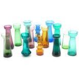 Fourteen coloured glass hyacinth vases all of elongated form, largest 20.5cm tall.