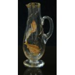 Attributed to Moser clear glass jug with enamelled decoration of fish and gilt decoration of plants,