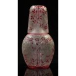 Baccarat carved cameo glass decanter and cup with cranberry decoration of flowers over an etched